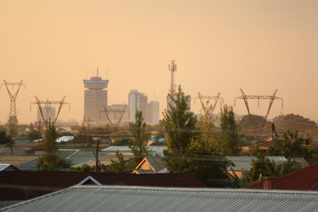 Current image: Lusaka, Zambia skyline at dusk, illustrating the country’s economic outlook